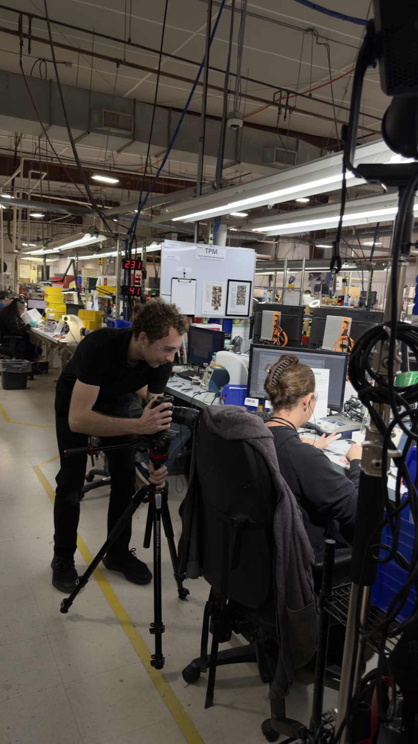 Second shooter filming on a manufacturing floor